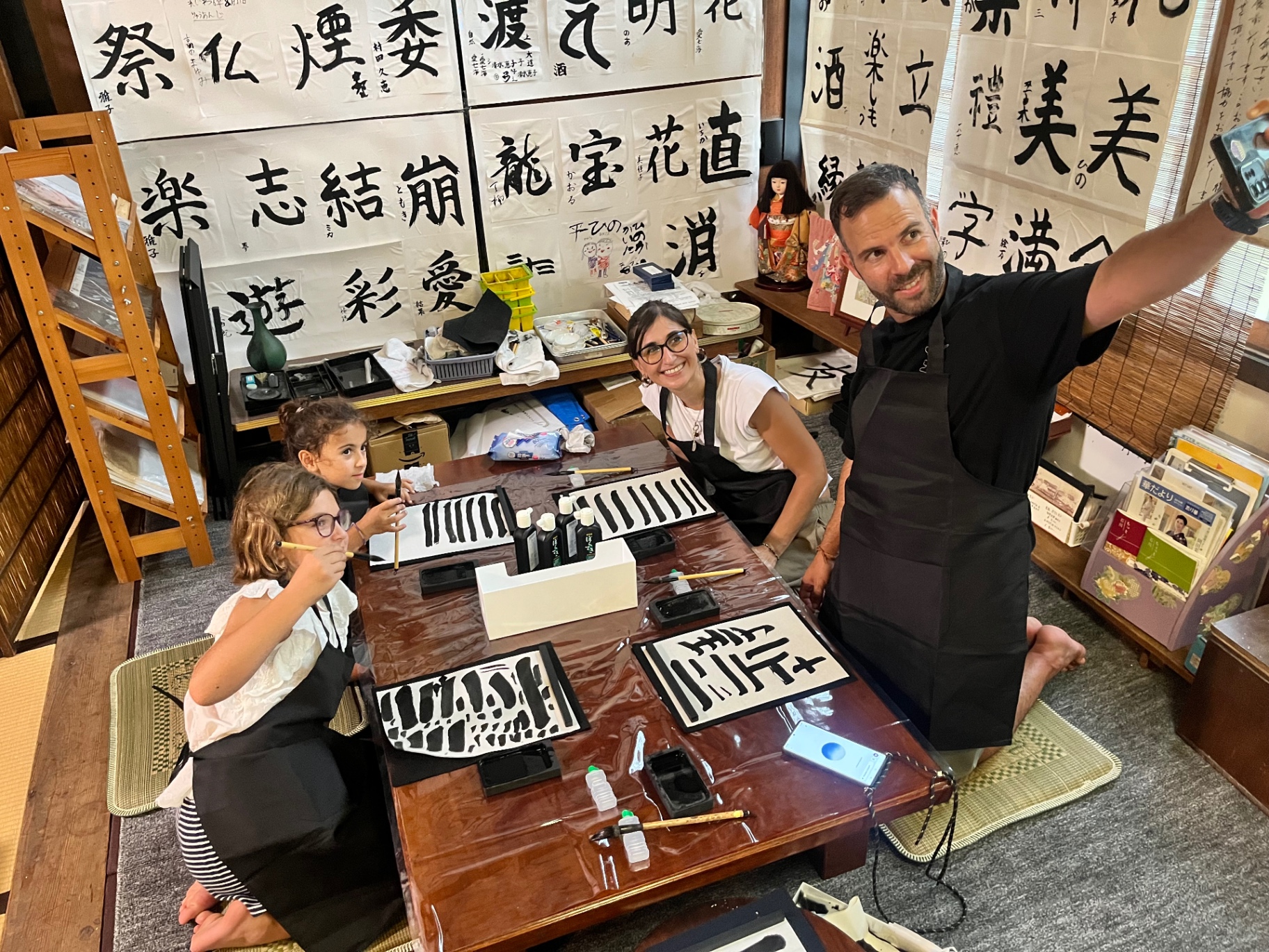 A guest practising Japanese calligraphy with a brush
